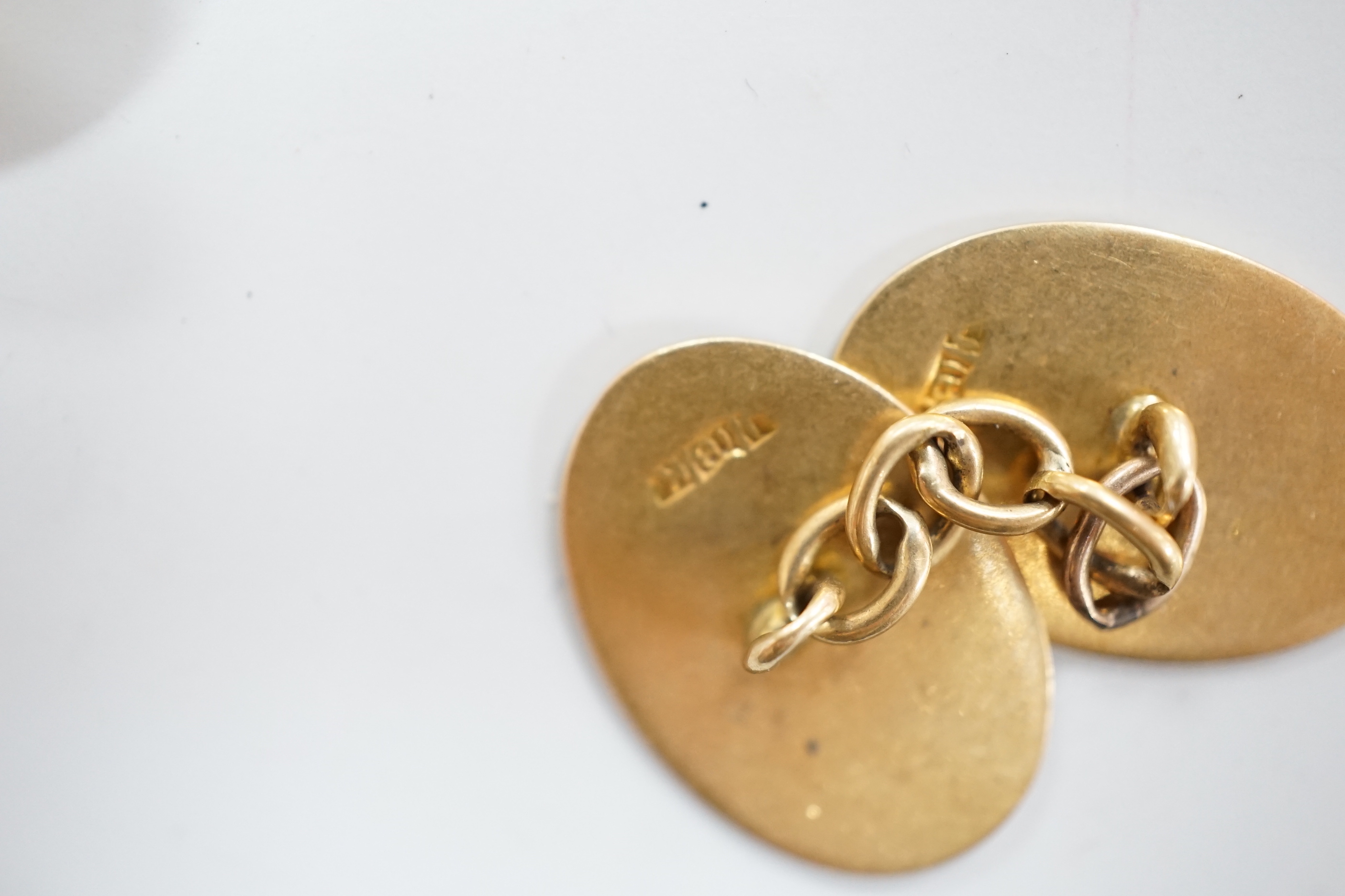 A pair of 18ct gold rectangular cufflinks, with enamelled initial N, 8.2 grams, and a pair of 18ct gold monogrammed oval cufflinks, 8 grams